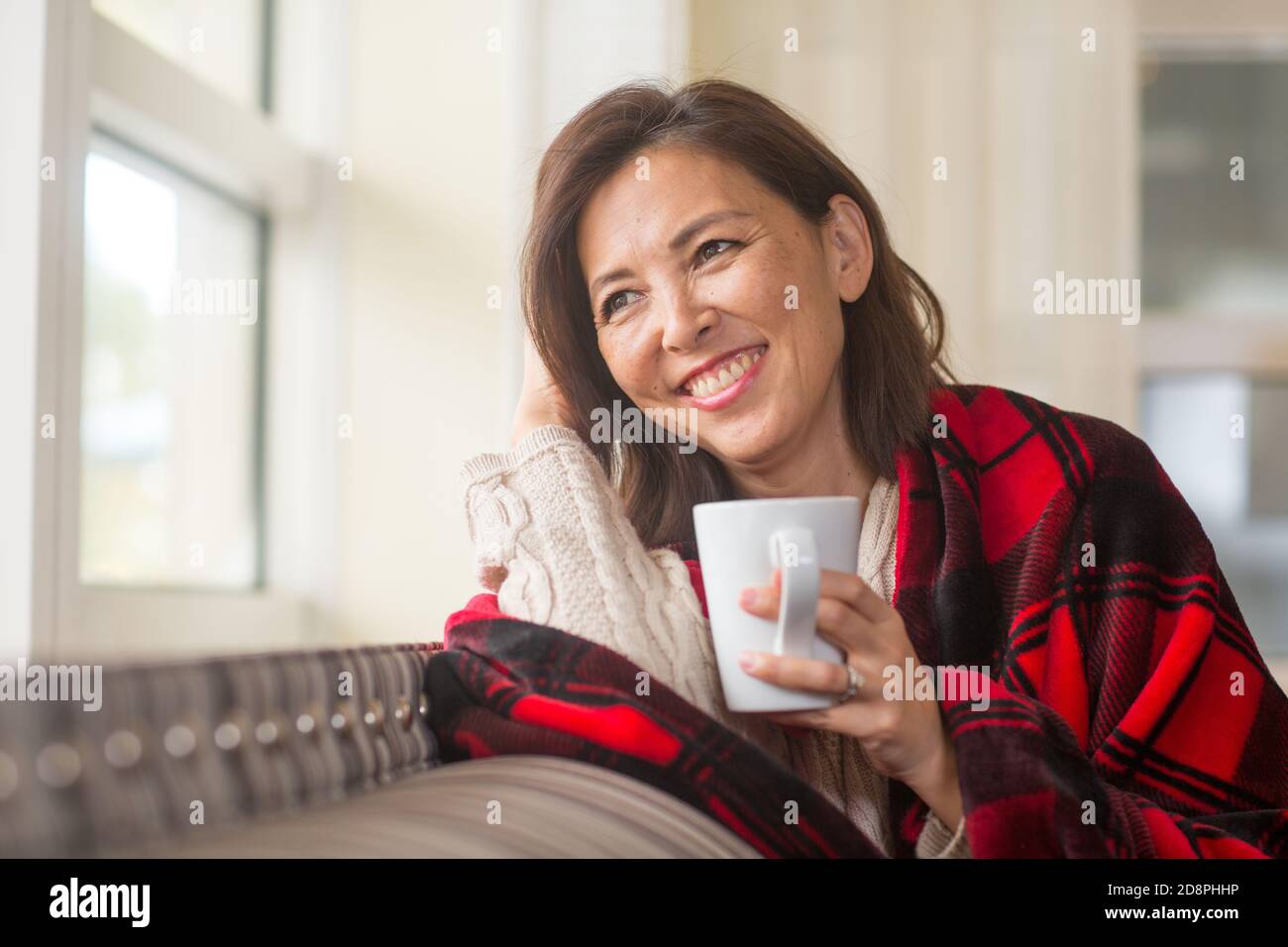 Donna asiatica matura che si gode una tazza di caffè. Foto Stock