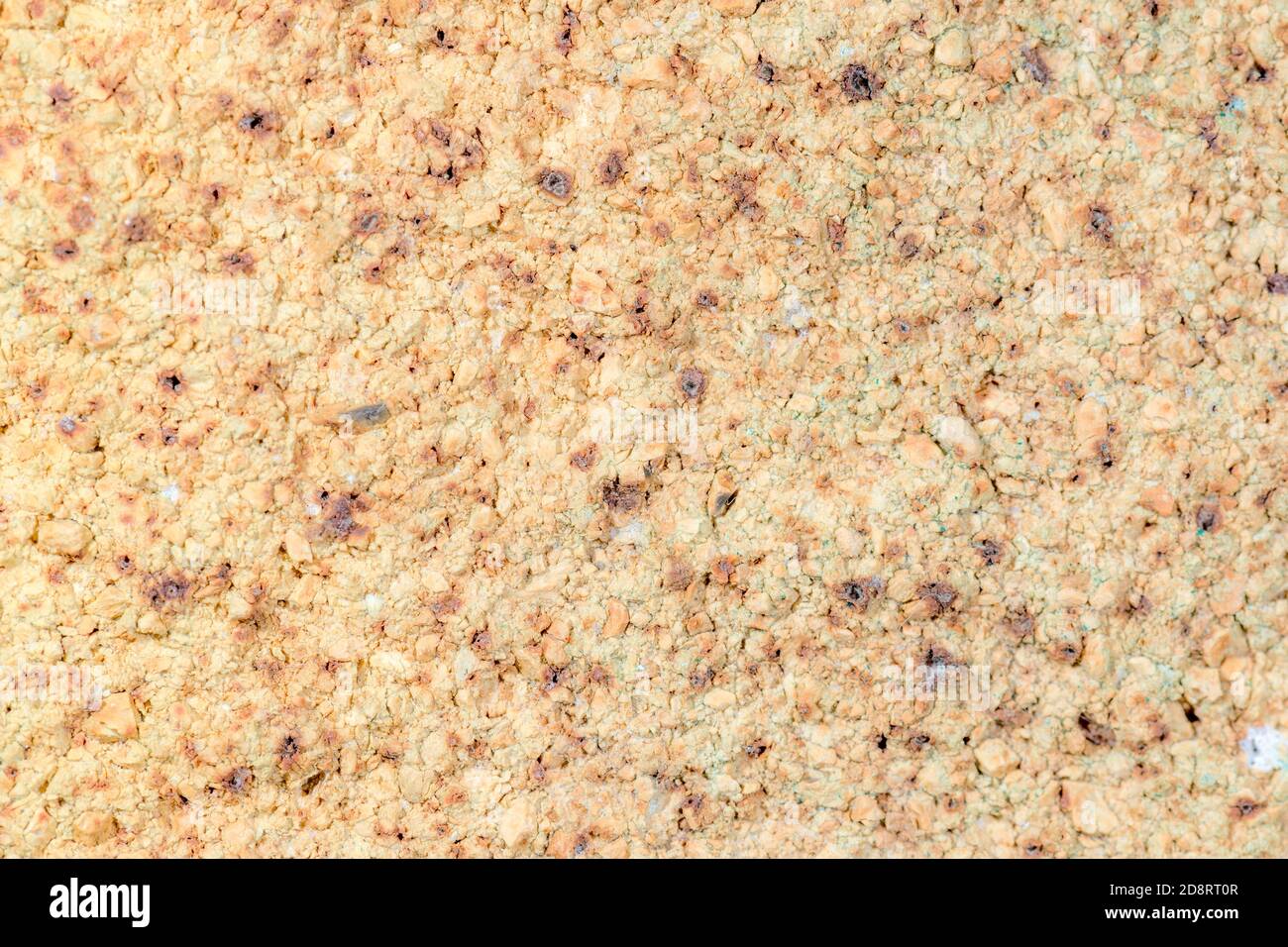 Un vecchio sfondo di pietra giallo, con intemperie. Foto Stock