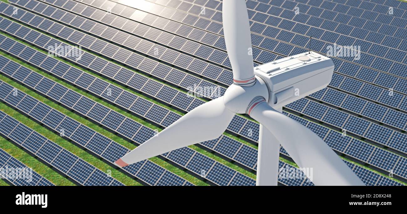 Spettacolare scatto aereo di un mulino a vento con un parco solare sullo sfondo. Foto Stock