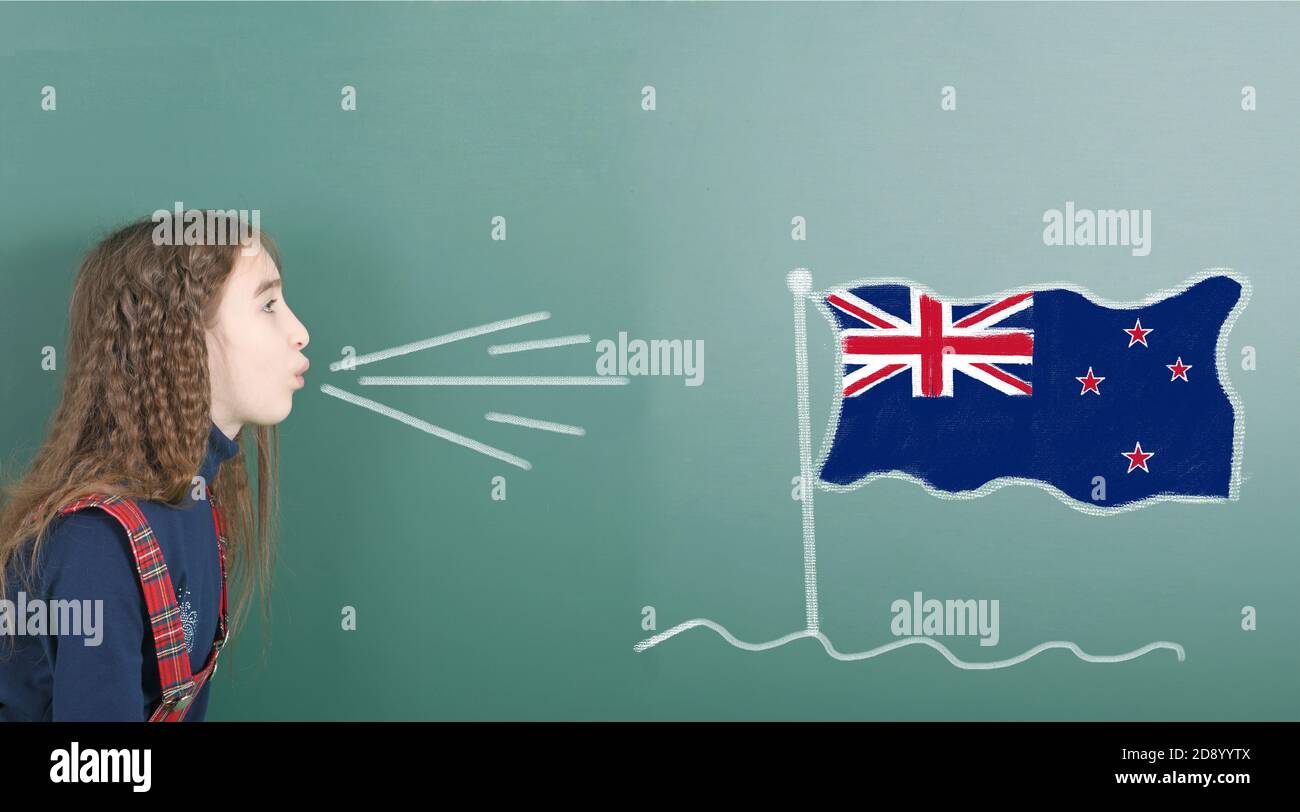 Ragazza pre-adolescente che soffia sul bordo della scuola disegnata sulla lavagna bandiera della Nuova Zelanda. Foto ad alta risoluzione. Profondità di campo completa. Foto Stock