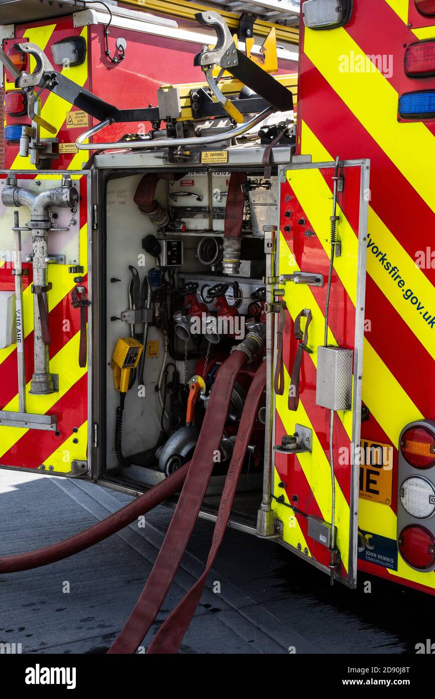 La vista posteriore di un motore antincendio inglese che mostra le pompe, i manichette e le varie attrezzature antincendio a bordo Foto Stock