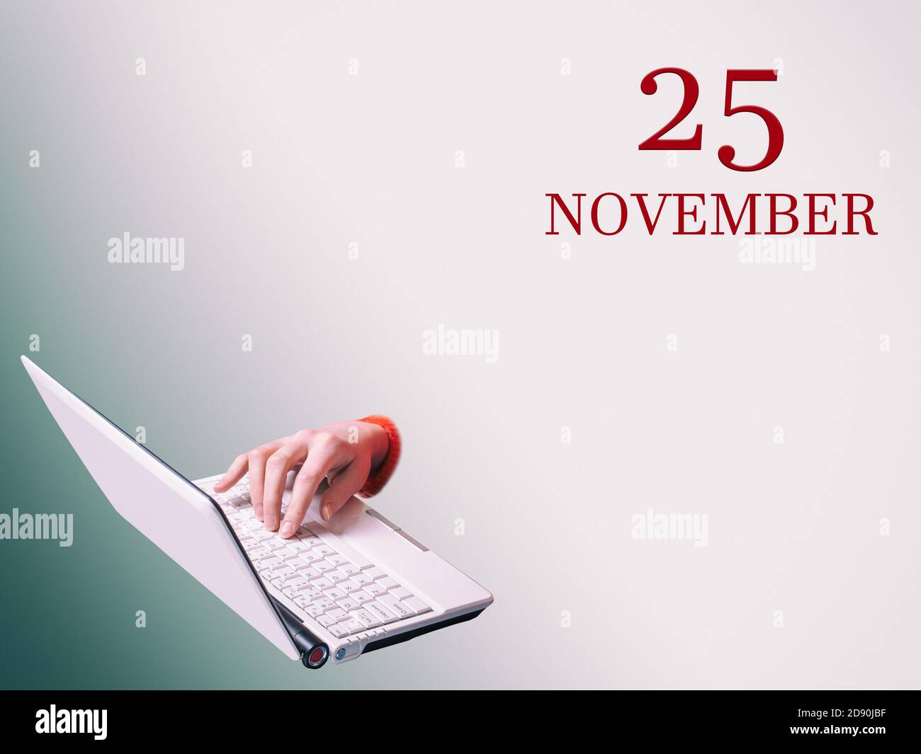 25 novembre. Una mano sta digitando su un computer portatile l'annuncio della data di una riunione o di un evento aziendale Foto Stock 25 novembre. Una mano sta digitando su un computer portatile l'annuncio della data di una riunione o di un evento aziendale Foto Stock