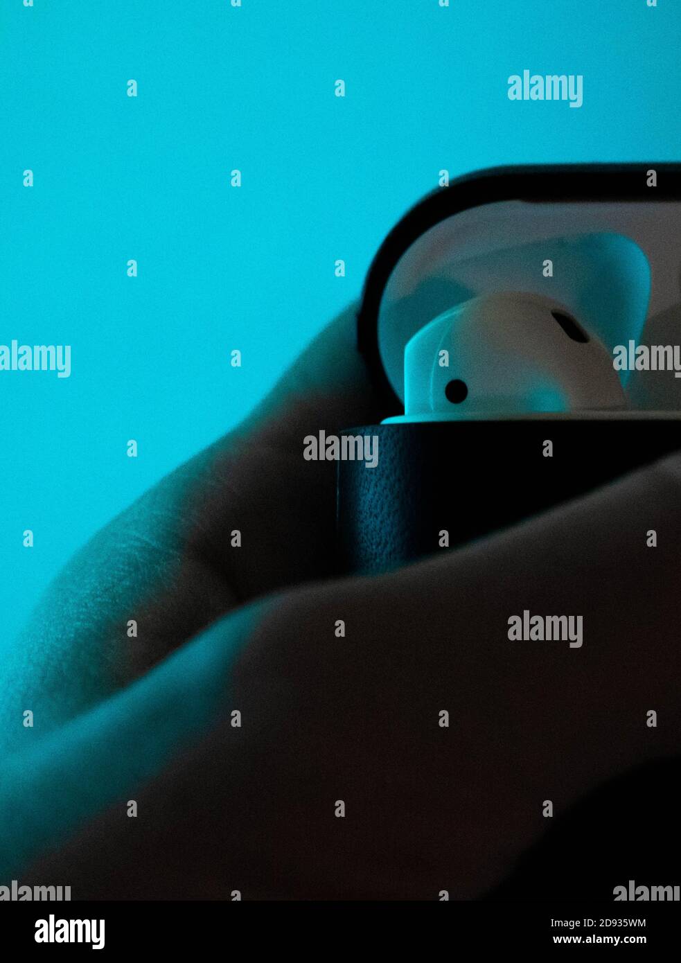Primo piano di una mano che tiene Apple Airpods Foto Stock