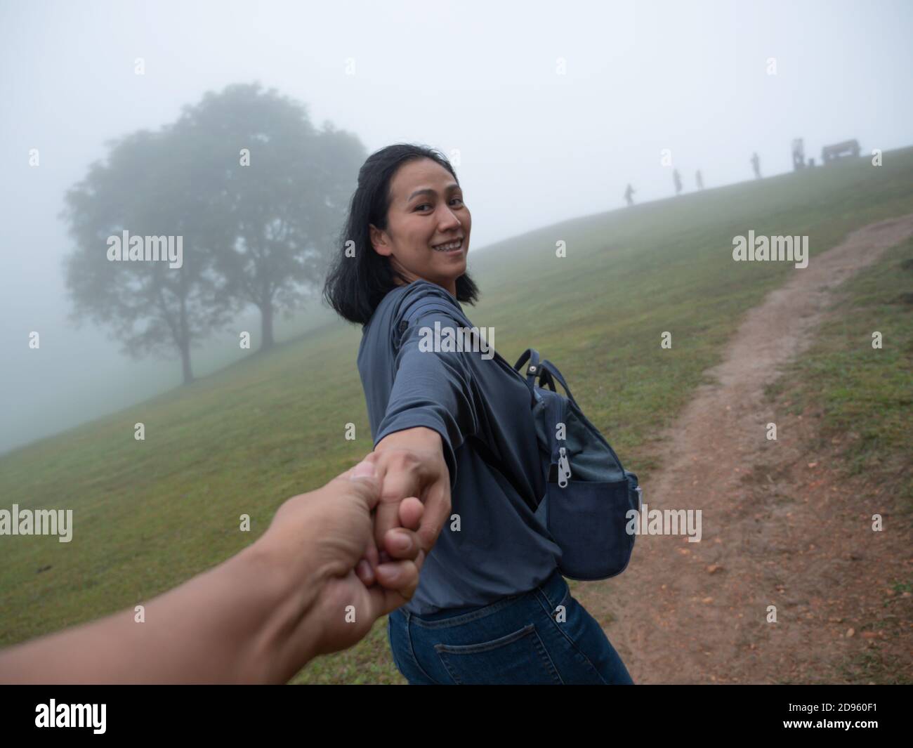 Coppia asiatica che tiene la mano sulla montagna Foto Stock
