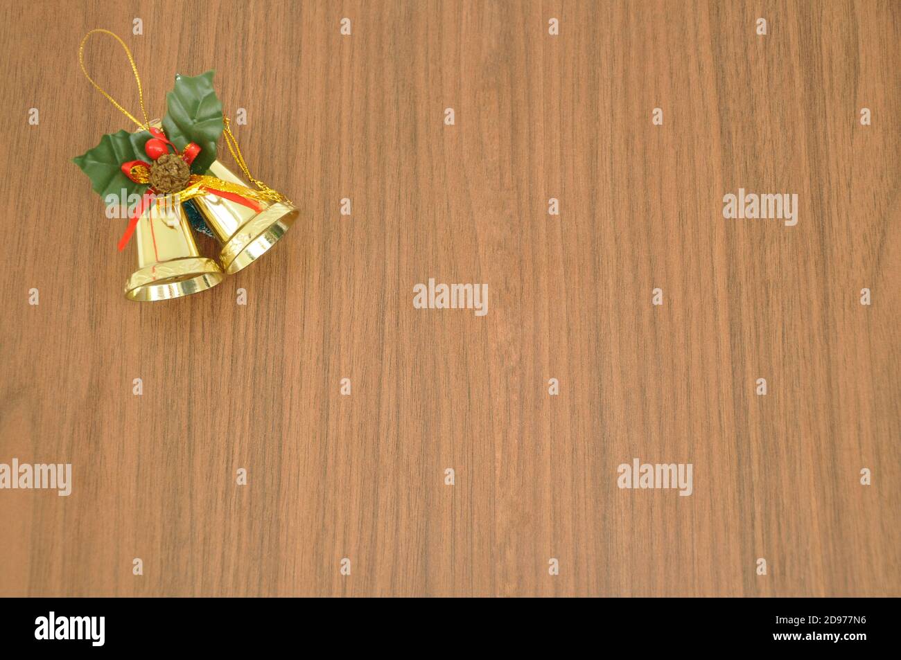 Campane di Natale. Campane di Natale in miniatura, con decorazione a foglia verde, usate come decorazione durante il Natale, su sfondo di legno, copy space, Brasile, Foto Stock