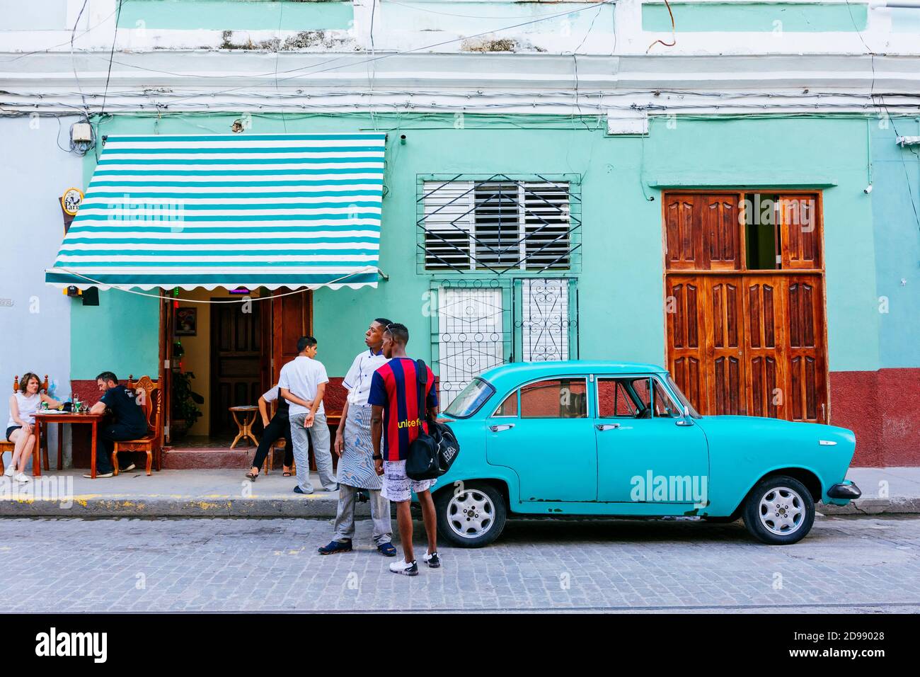 Cubani che chiacchierano nel tardo pomeriggio. Si indossa una maglietta di Barcellona F.C..Cienfuegos, Cuba, America Latina e Caraibi Foto Stock