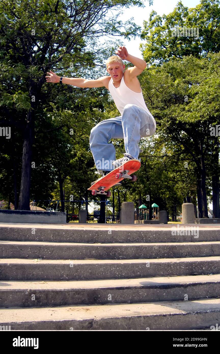 Skateboarder che esegue trucchi sul suo skate board Foto Stock