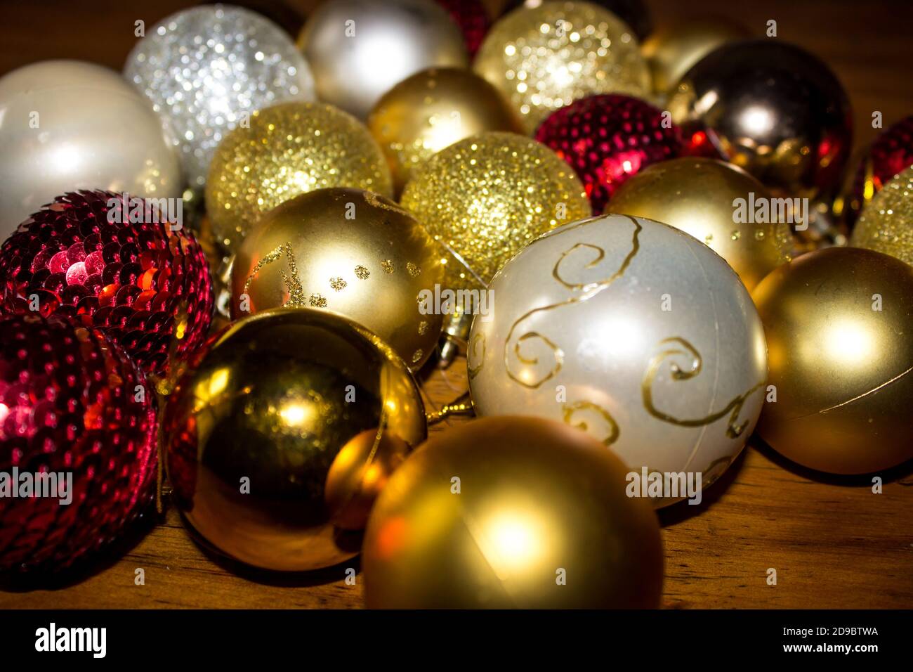 Una grande quantità di diverse palline di Natale di colore rosso, oro e crema  di diverse texture, su un tavolo Foto stock - Alamy