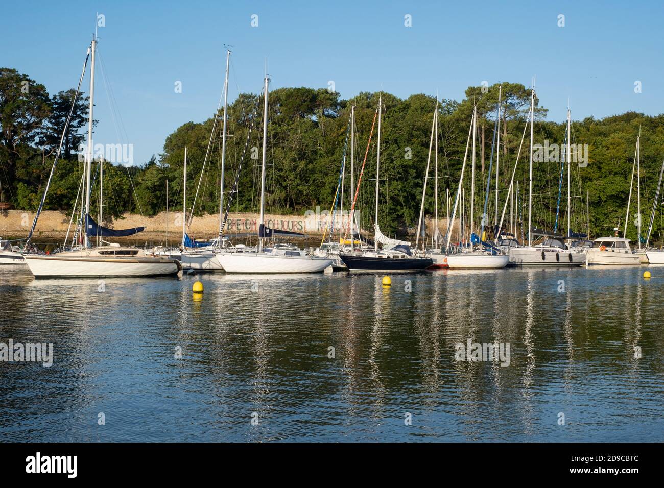 Barche a vela ormeggiate al largo di Conleau Beach sul Golfo di Morbihan, Vannes, Bretagna, Francia. Graffiti in francese recita "Always Breton!" Foto Stock