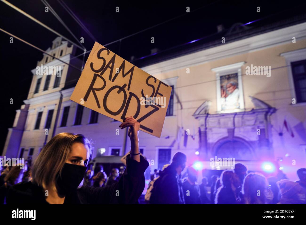 Un manifestante con un cartello che dice 'Dive the birth by yourself' passa accanto alla famosa 'finestra papale' nell'edificio della Curia, da cui Papa Giovanni Paolo Foto Stock