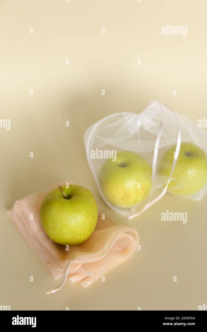 Mele non ogm in sacchetti riutilizzabili ecofriendly trasparenti su sfondo luminoso con spazio per la copia. Foto Stock