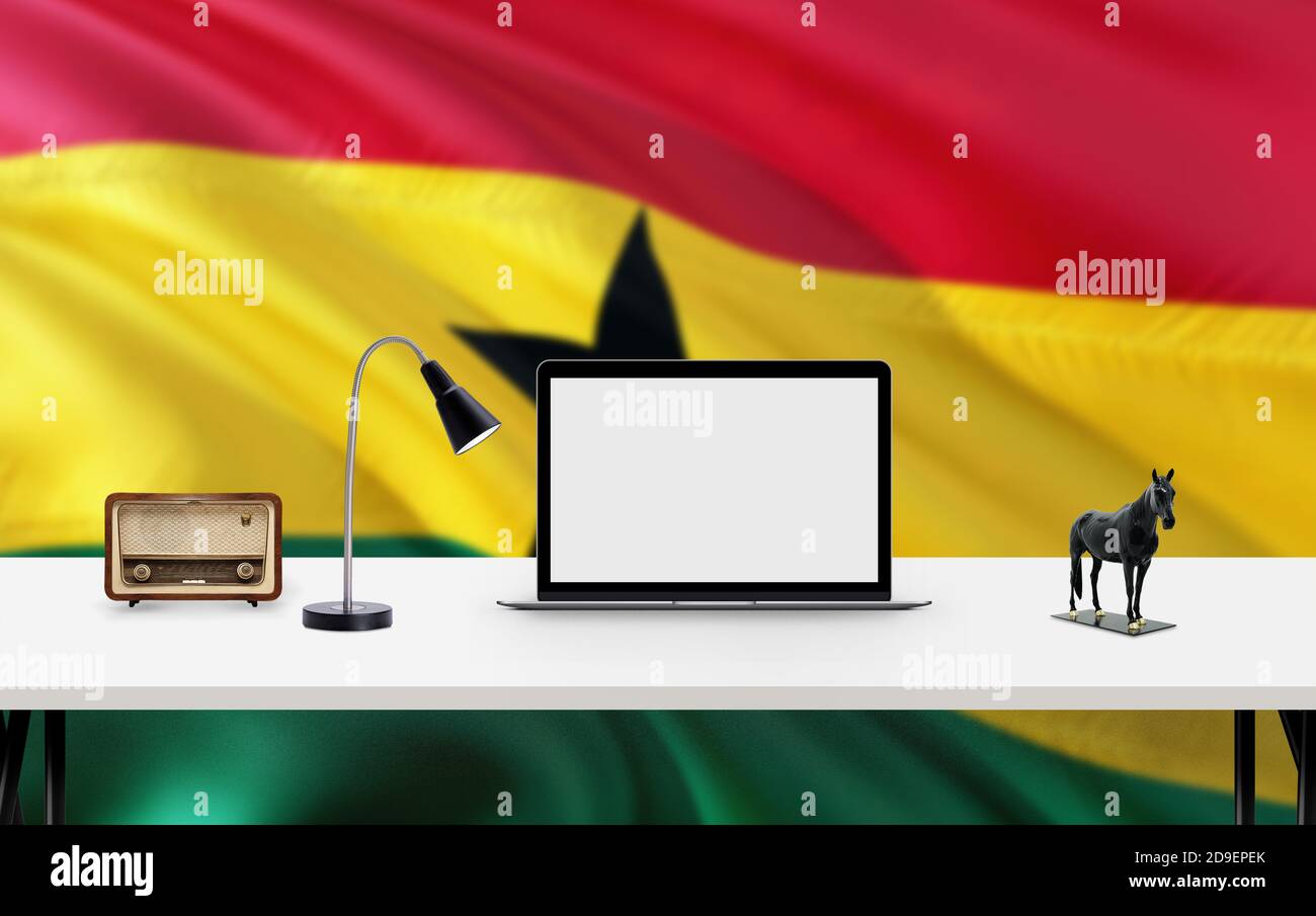 Ghana bandiera nazionale sfondo con spazio di lavoro, computer desktop e accessori per ufficio su bianco tavolo moderno. Foto Stock