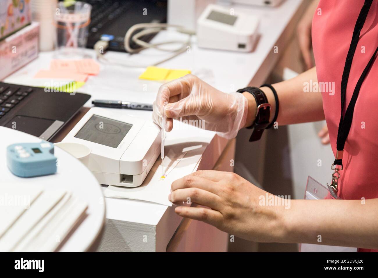 Tecnico che esegue test di salute orale tramite analisi della saliva Foto Stock