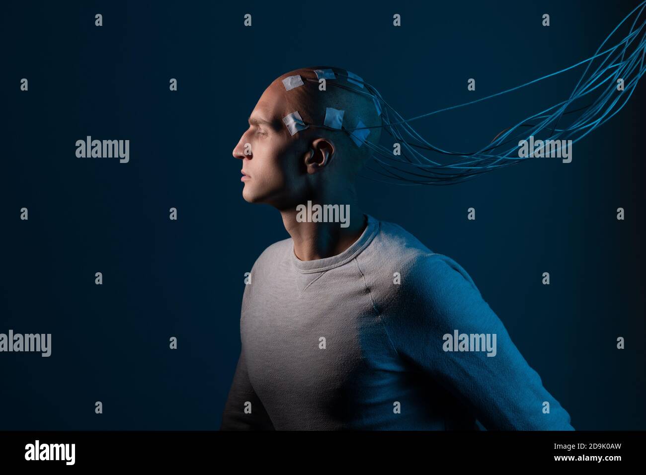 L'uomo con gli elettrodi nella testa è un concetto futuristico di realtà virtuale e controllo mentale. Interfaccia neurologica, contatto biologico e meccanico. Foto Stock