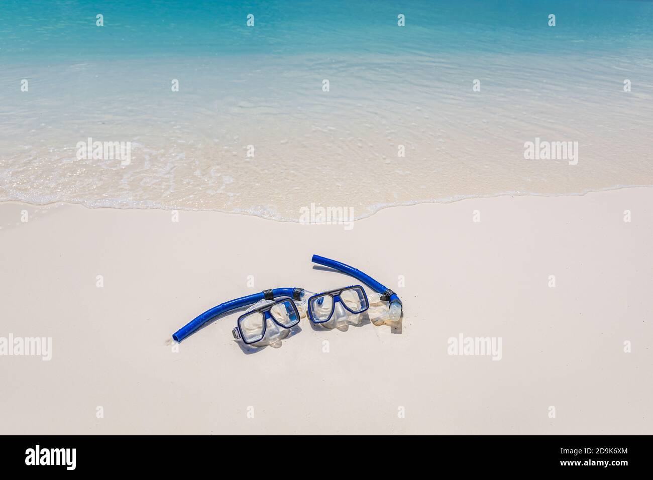 Due maschere e attrezzatura da snorkeling nelle onde di surf della spiaggia di sabbia. Attività sportive esotiche all'aperto, hobby ricreativo. Spiaggia sabbia e vista mare paesaggio Foto Stock