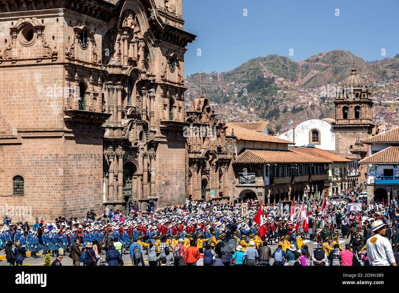 Gruppi di scuole per bambini in parata durante l'evento Juramentacion de Policias Ecolares, la Chiesa Compania de Jesus sulla sinistra, Plaza de Armas, Cusco, Perù Foto Stock