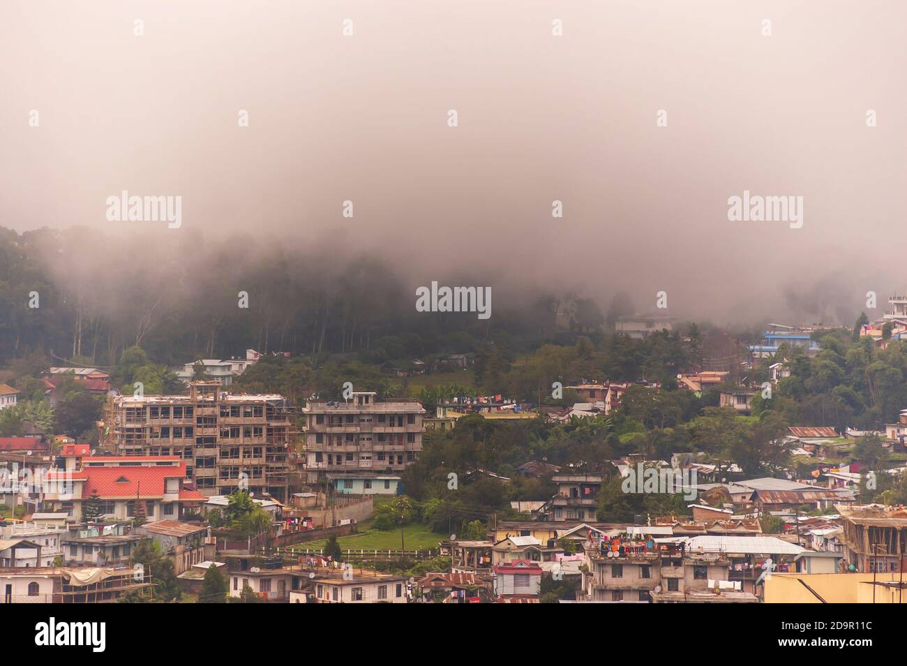 La nebbia scorre nella città di Shillong a Meghalaya, India, dall'altra parte della montagna dopo una tempesta pomeridiana durante la stagione monsonica. Foto Stock