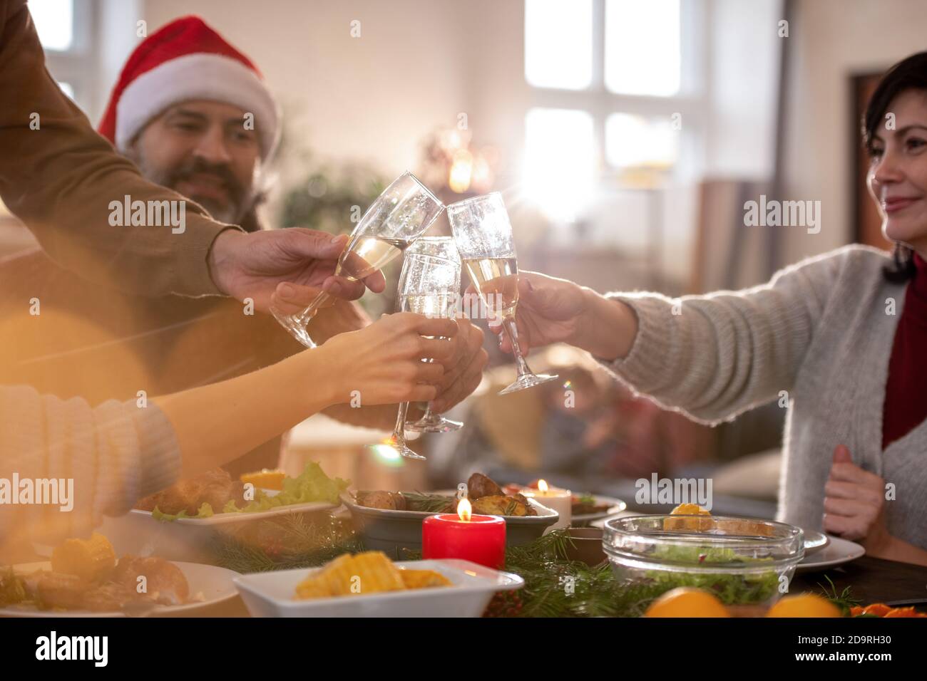 Due coppie con flute di champagne sopra il tavolo delle feste per cena Foto Stock