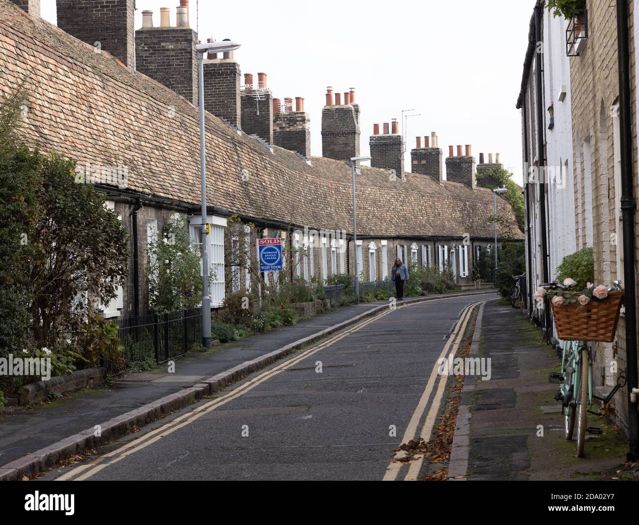 Fila di piccoli cottage inglesi classici a un piano nella stretta strada di Orchard Street, Cambridge Foto Stock