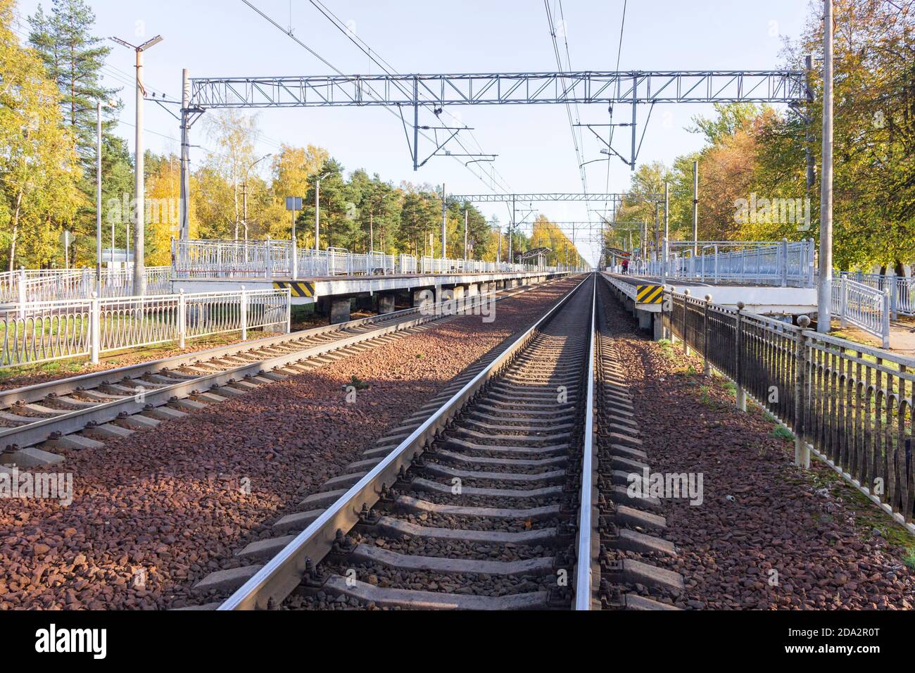 Binari ferroviari con traversine in cemento che si estendono oltre l'orizzonte. Foto Stock