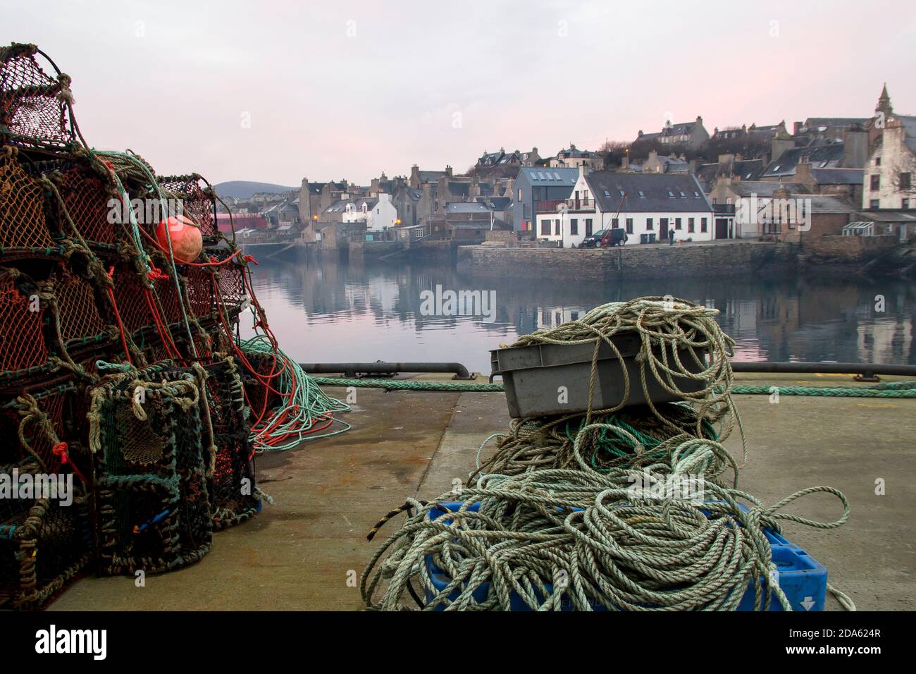 Misty pesca porto scozzese a Stromness sulle isole Orkney con creme e corde al mattino Foto Stock