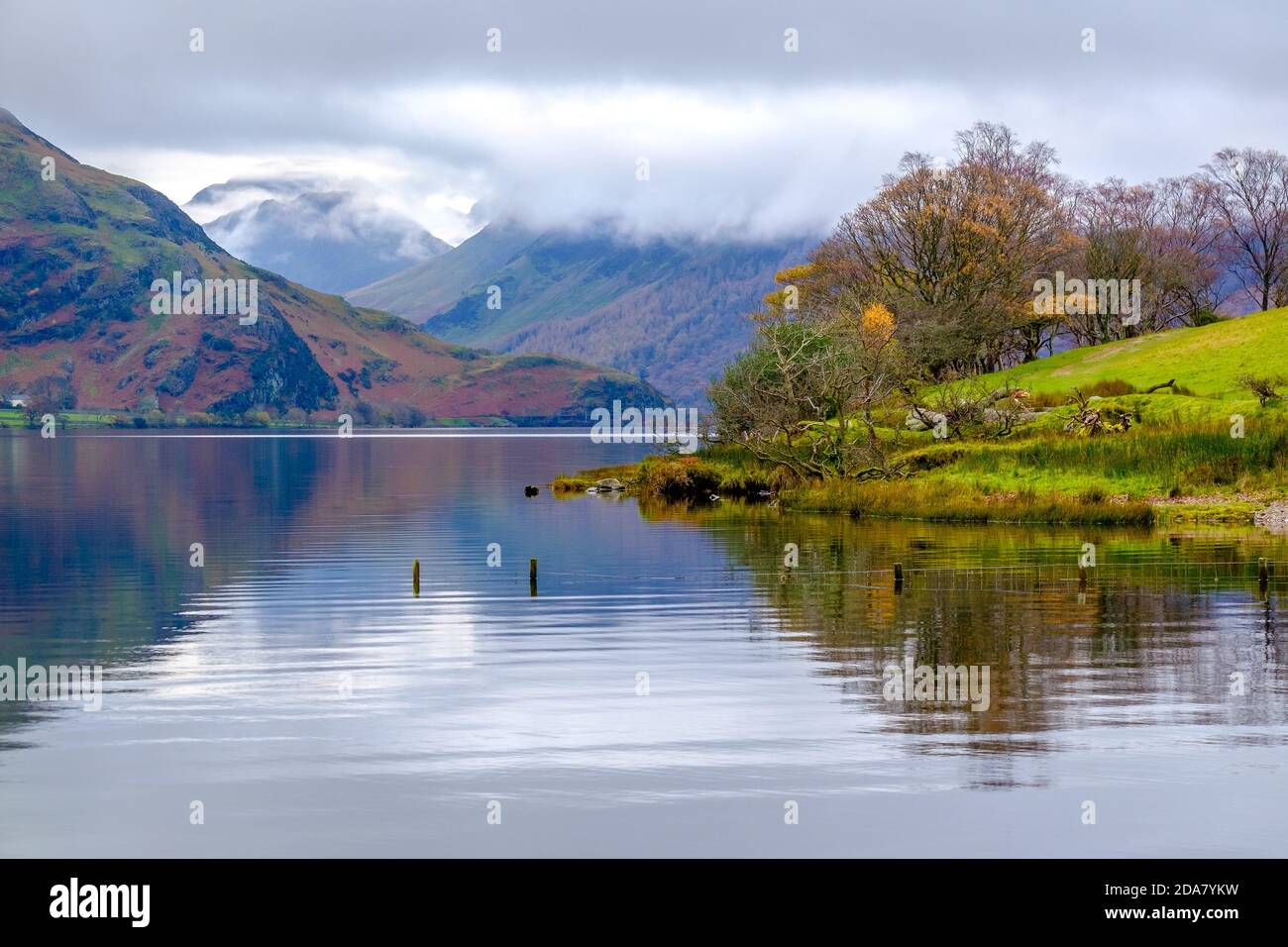 Crummock Water nel nord-ovest Lake District National Park, Cumbria. Le campane intorno a Buttermere in lontananza Foto Stock