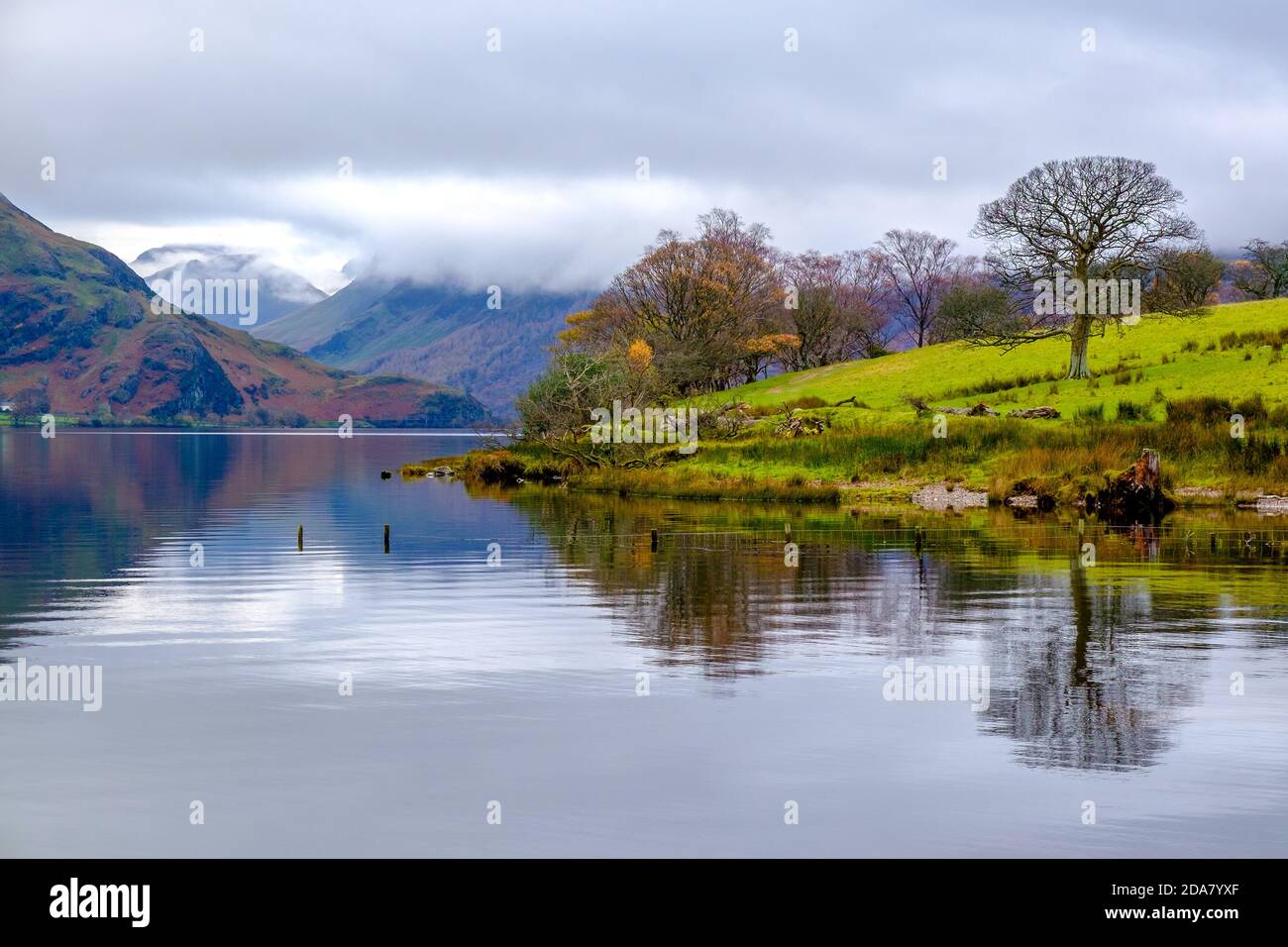 Crummock Water nel nord-ovest Lake District National Park, Cumbria. Le campane intorno a Buttermere in lontananza Foto Stock
