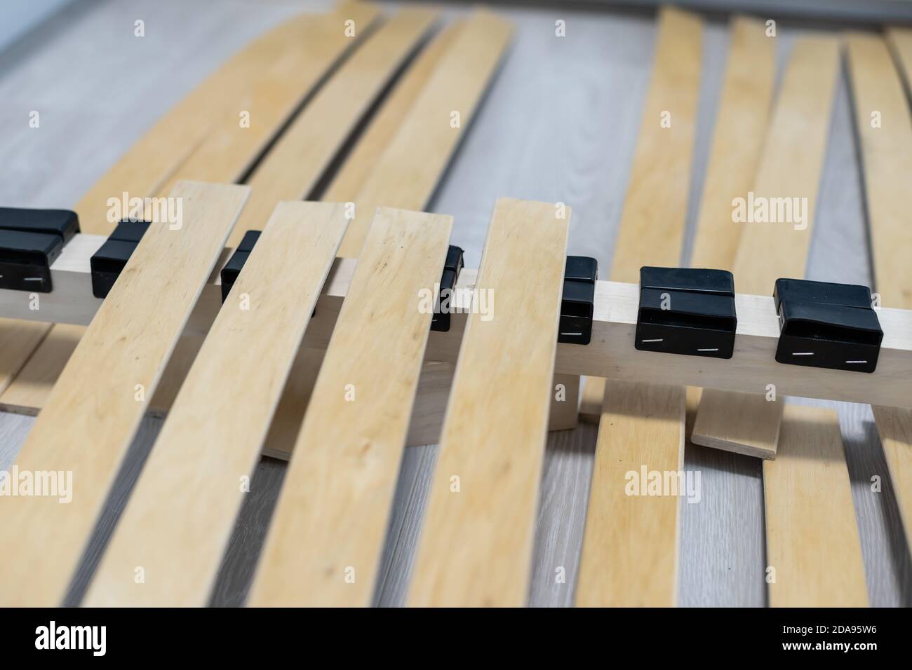 Tavola di legno rotta o lamella nel letto. Necessità di riparazione di mobili. Foto Stock