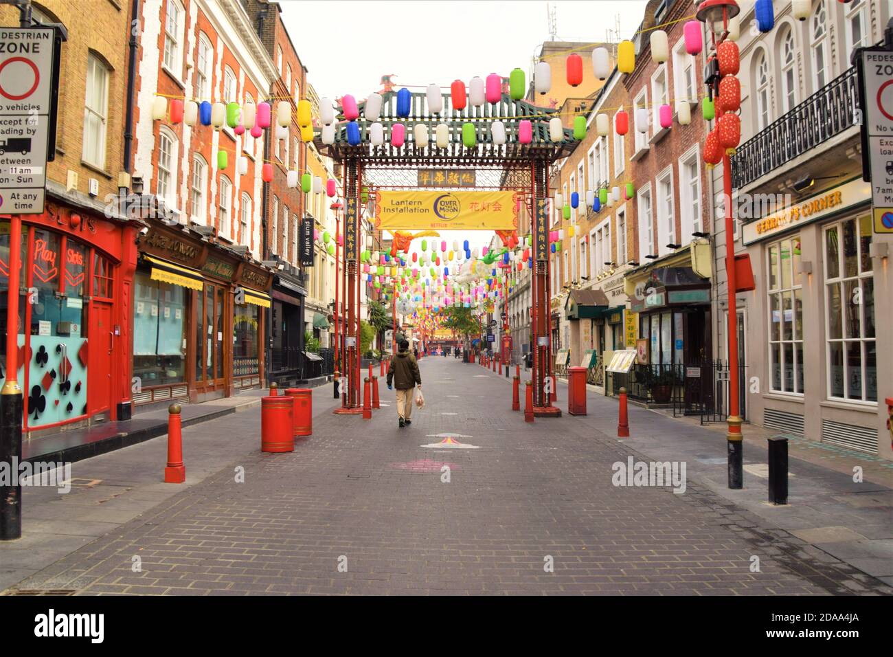 Un uomo cammina lungo una vuota Gerrard Street a Chinatown, Londra, durante il secondo blocco nazionale in Inghilterra. Foto Stock