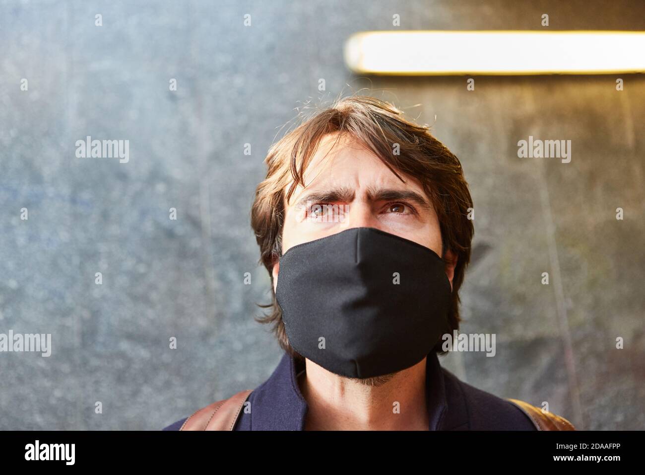 Uomo con maschera facciale come prevenzione contro il coronavirus in Covid-19 pandemia Foto Stock