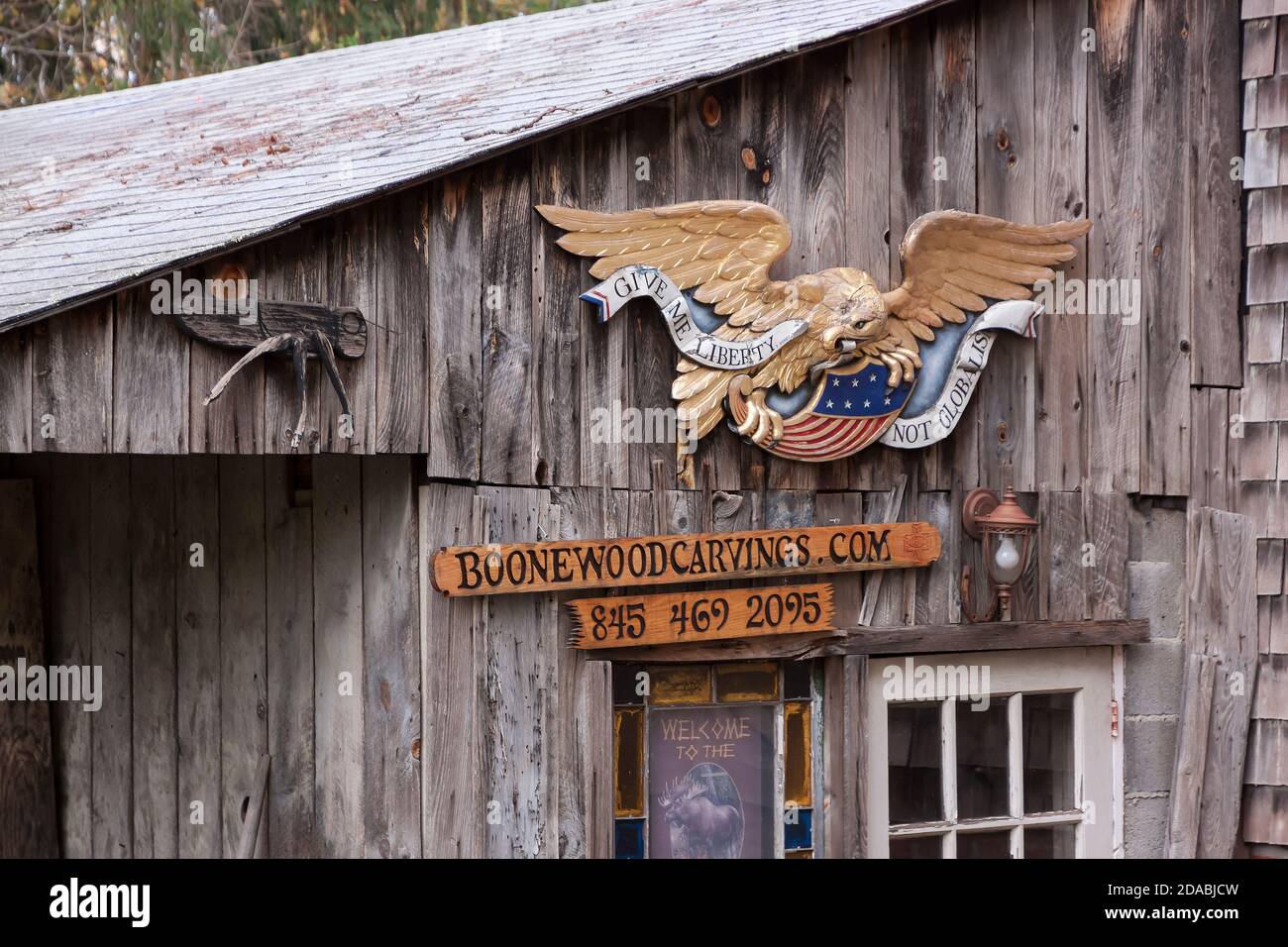 Boone ha personalizzato la scultura in legno e insegna business di fronte al suo studio a Sugarloaf Village, Chester, New York, Stati Uniti. Foto Stock