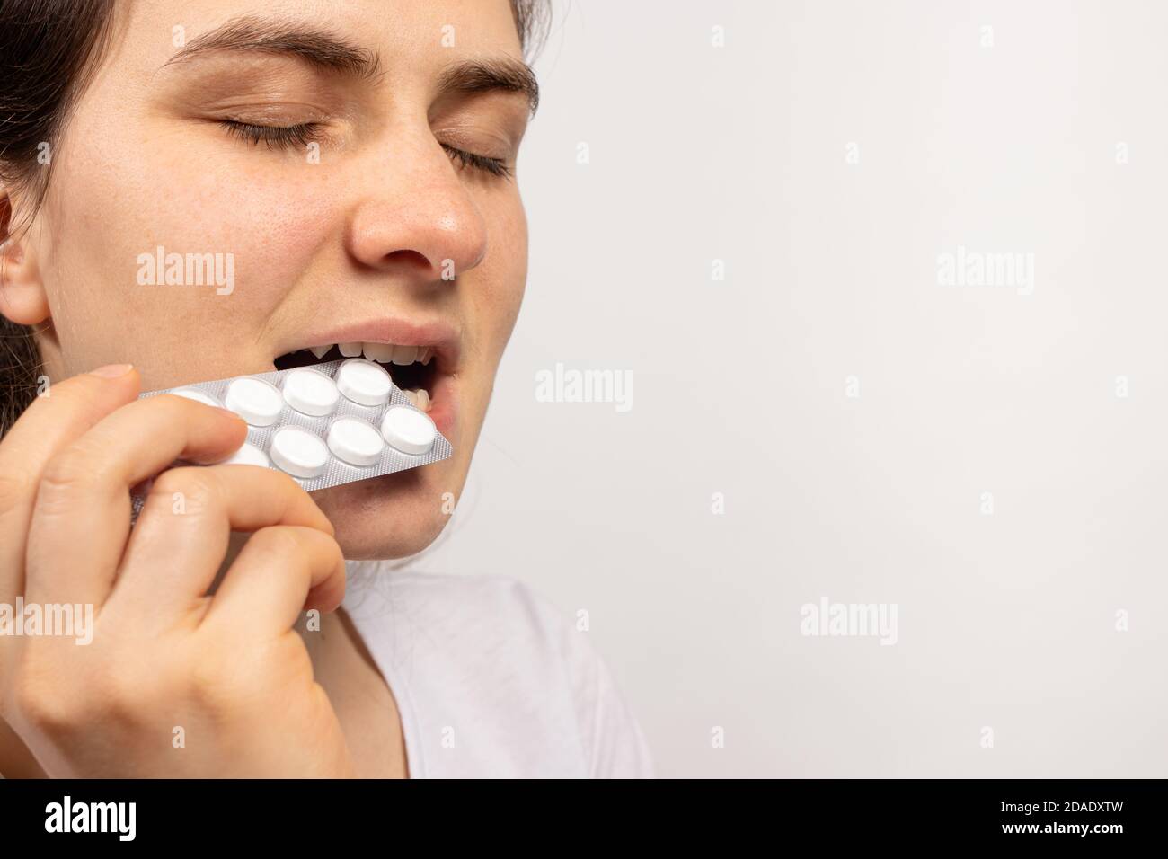 Un uomo mangia pillole di farmaci. Il problema di prendere antibiotici senza indicazioni. Trattare le malattie in medicina con l'aiuto della farmacia Foto Stock