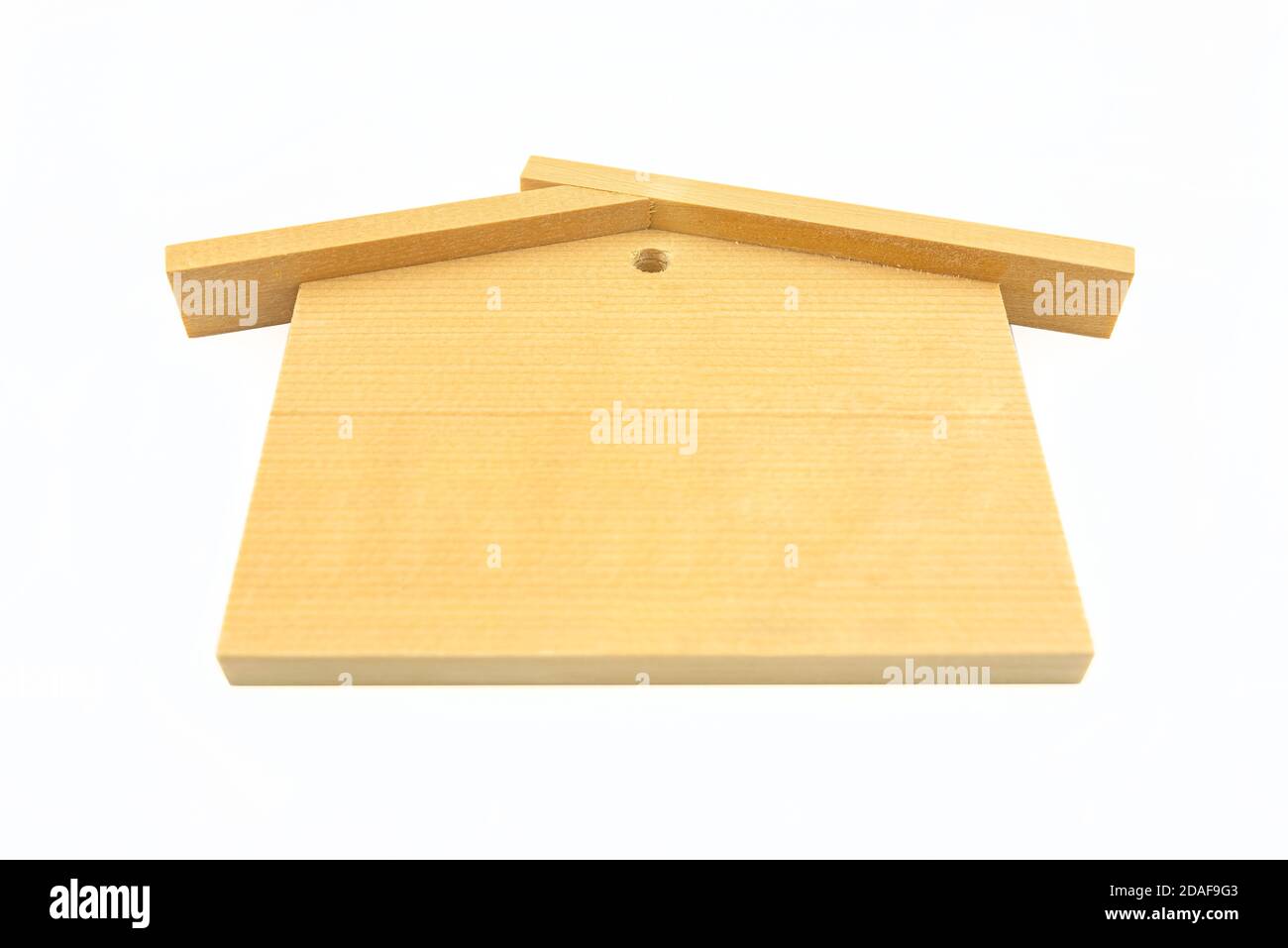 Una piccola casa di legno con tetto a tegole, isolata su sfondo bianco con un percorso di ritaglio. Foto Stock