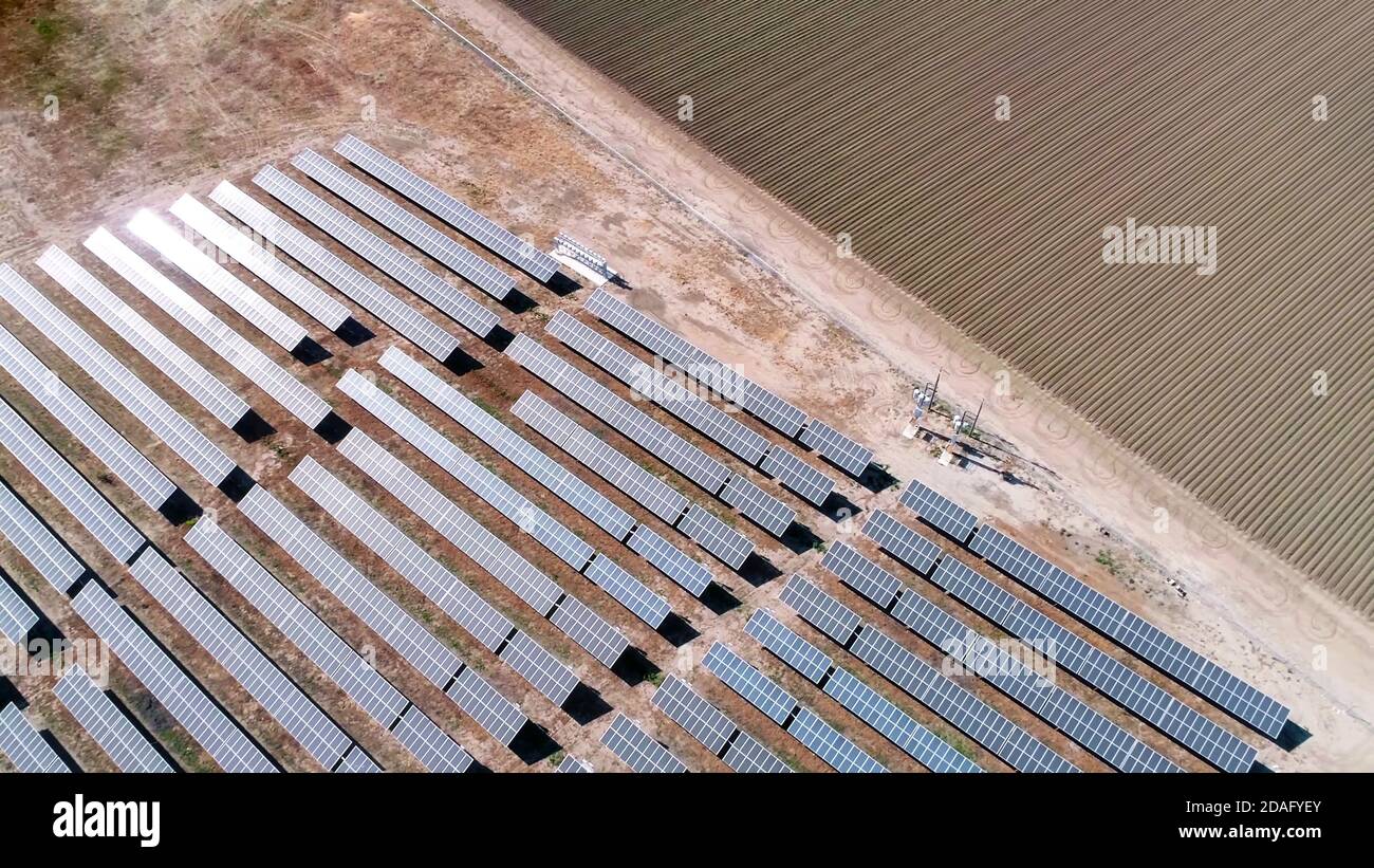 vista aerea dei pannelli di energia solare e del campo agricolo arato Foto Stock