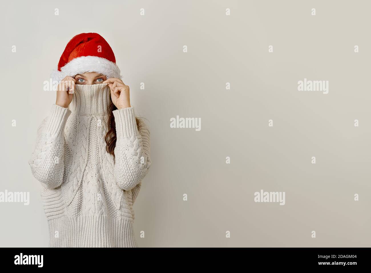 Donna in cappello di santa sulla testa, coprendo il viso con un collare Foto Stock