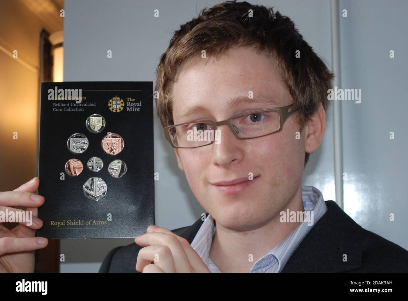 Matthew Dent, designer gallese di moneta, al lancio della Royal Mint di nuove monete della sterlina, Tower of London, 2008, qui che contiene tutte e sei le monete. Foto Stock