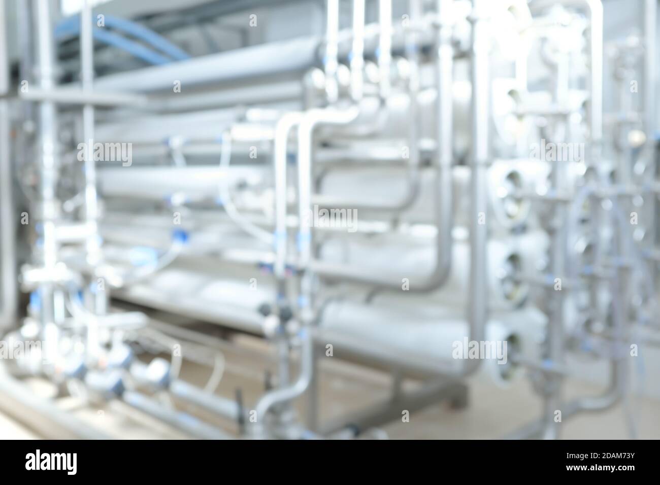 Tubi e tubi ad osmosi inversa sfocati o sfocati per un trattamento dell'acqua di fondo industriale di purificazione. Foto Stock