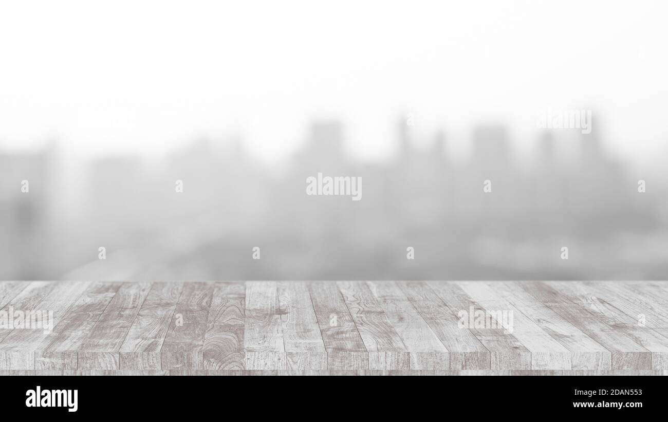 Tavolo in legno bianco con sfocatura città edificio esterno sfondo per la pubblicità montaggio. Foto Stock