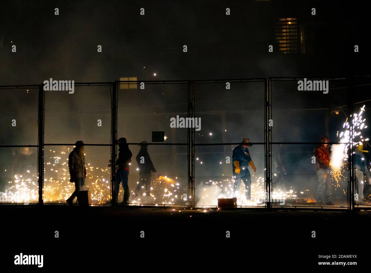 Fuochi d'artificio di un festival tradizionale di Valencia chiamato 'cordá'. Uomini bloccati in una gabbia di metallo che spara i firecrackers Foto Stock