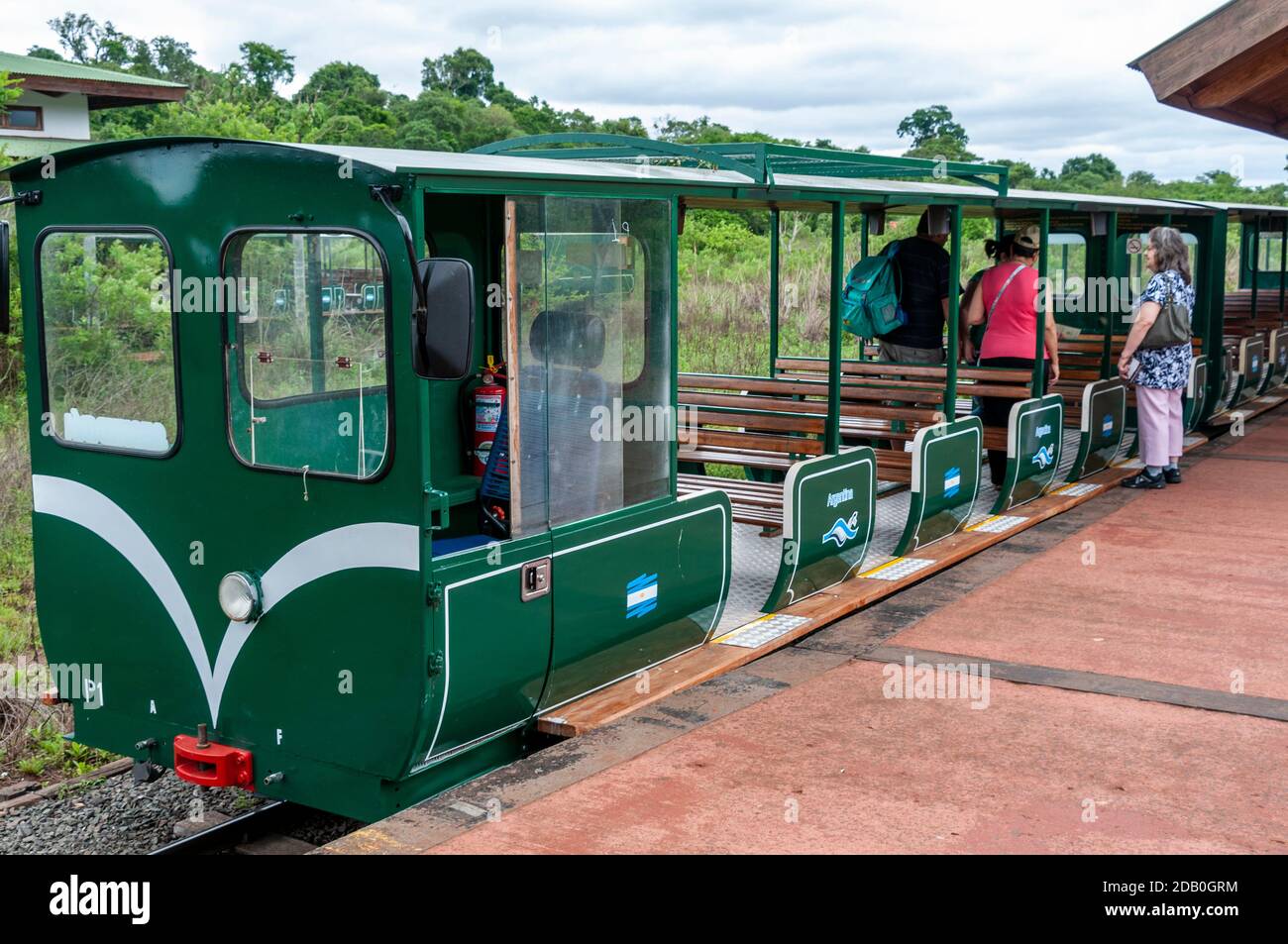 I passeggeri salpano sul treno della giungla (treno ecologico della foresta pluviale) che si avvicina alla stazione centrale nel Parco Nazionale di Iguazu, Argentina. Il trenino Foto Stock