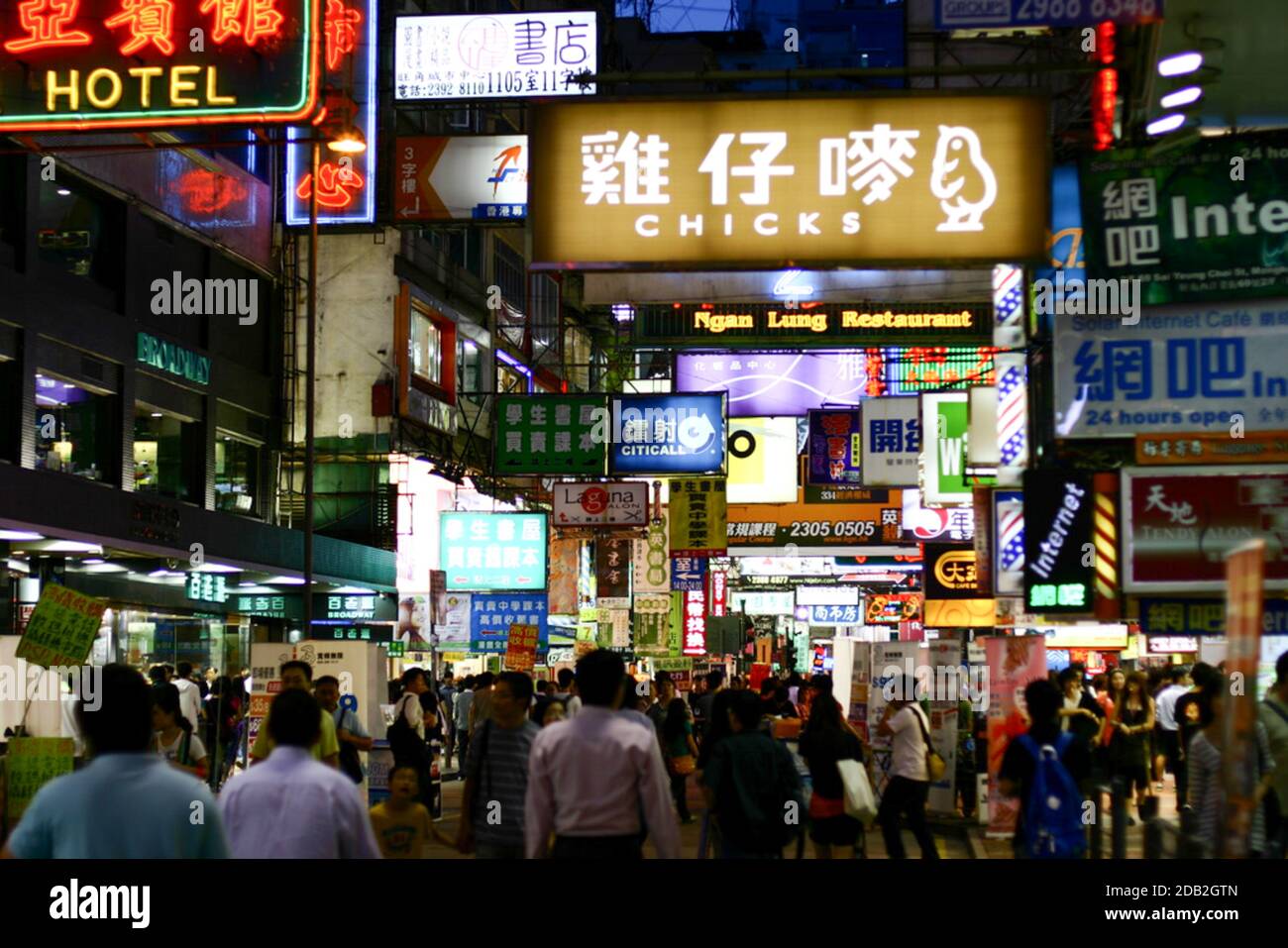 folla che cammina senza maschera nel centro di hong kong, vista notturna con cartelli illuminati Foto Stock