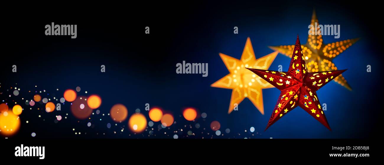 Lanterne rosse e dorate per Natale su sfondo blu scuro e nero, formato extra large con spazio per la copia Foto Stock Lanterne rosse e dorate per Natale su sfondo blu scuro e nero, formato extra large con spazio per la copia Foto Stock