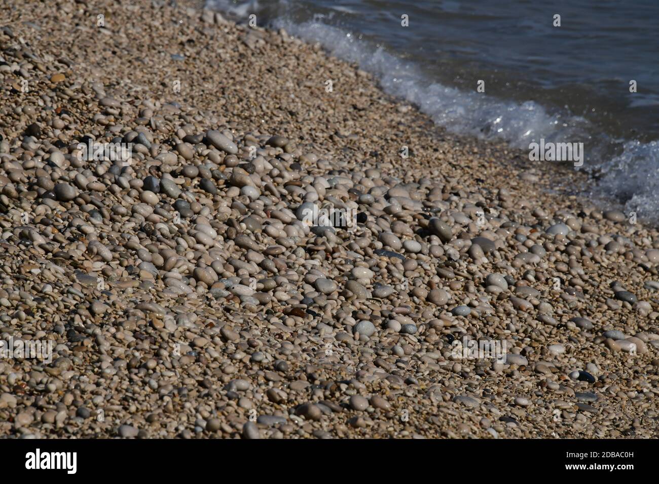 Pietre grandi, piccole, rotonde sulla spiaggia mediterranea in provincia di Alicante, Spagna Foto Stock
