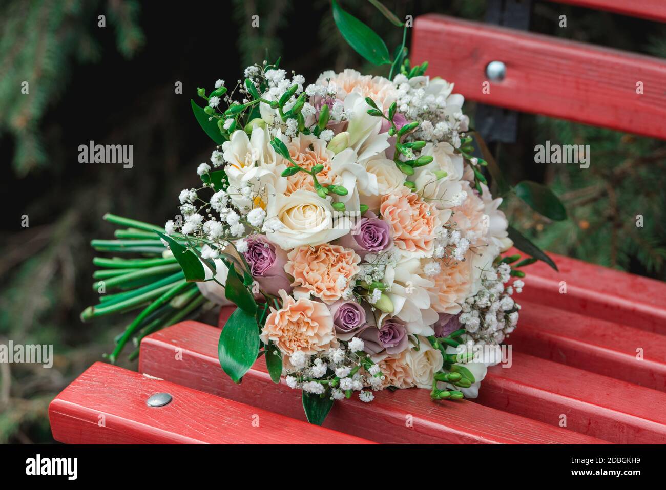 arancio con bouquet di fiori bianchi giace su una panchina Foto Stock