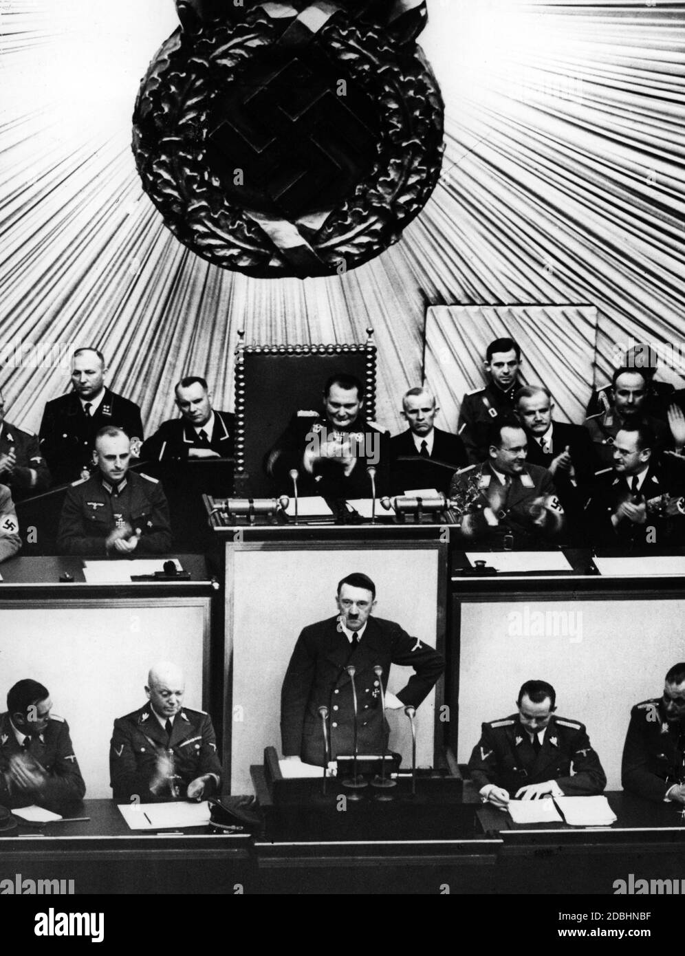 "Adolf Hitler durante la sessione del Reichstag del 1° settembre 1939. Nel suo discorso, Hitler giustifica l'invasione tedesca della Polonia. Il detto molto citato 'seid 5 Uhr 45 wird zurueckgeschossen' (stiamo restituendo il fuoco dalle 5:45 del mattino) proviene da quel discorso. Infatti la lotta contro il Danzig Westerplatte iniziò già alle 4:45 con l'artiglieria navale. Il raid aereo su Wielun è iniziato un'ora dopo. Il motivo dell'attacco tedesco fu un'azione di commando che gli uomini delle SS avevano temuto contro la stazione radio di Gleiwitz nei pressi di Breslau. La dichiarazione di Hitler recita nella sua interezza: ''questa notte per il Foto Stock