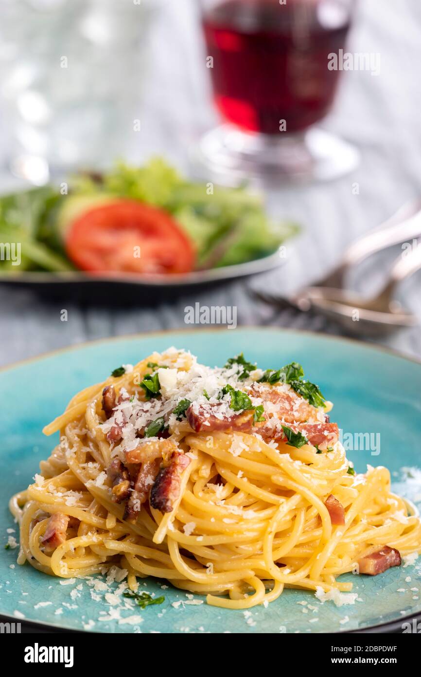 spaghetti alla carbonara su un piatto blu Foto Stock
