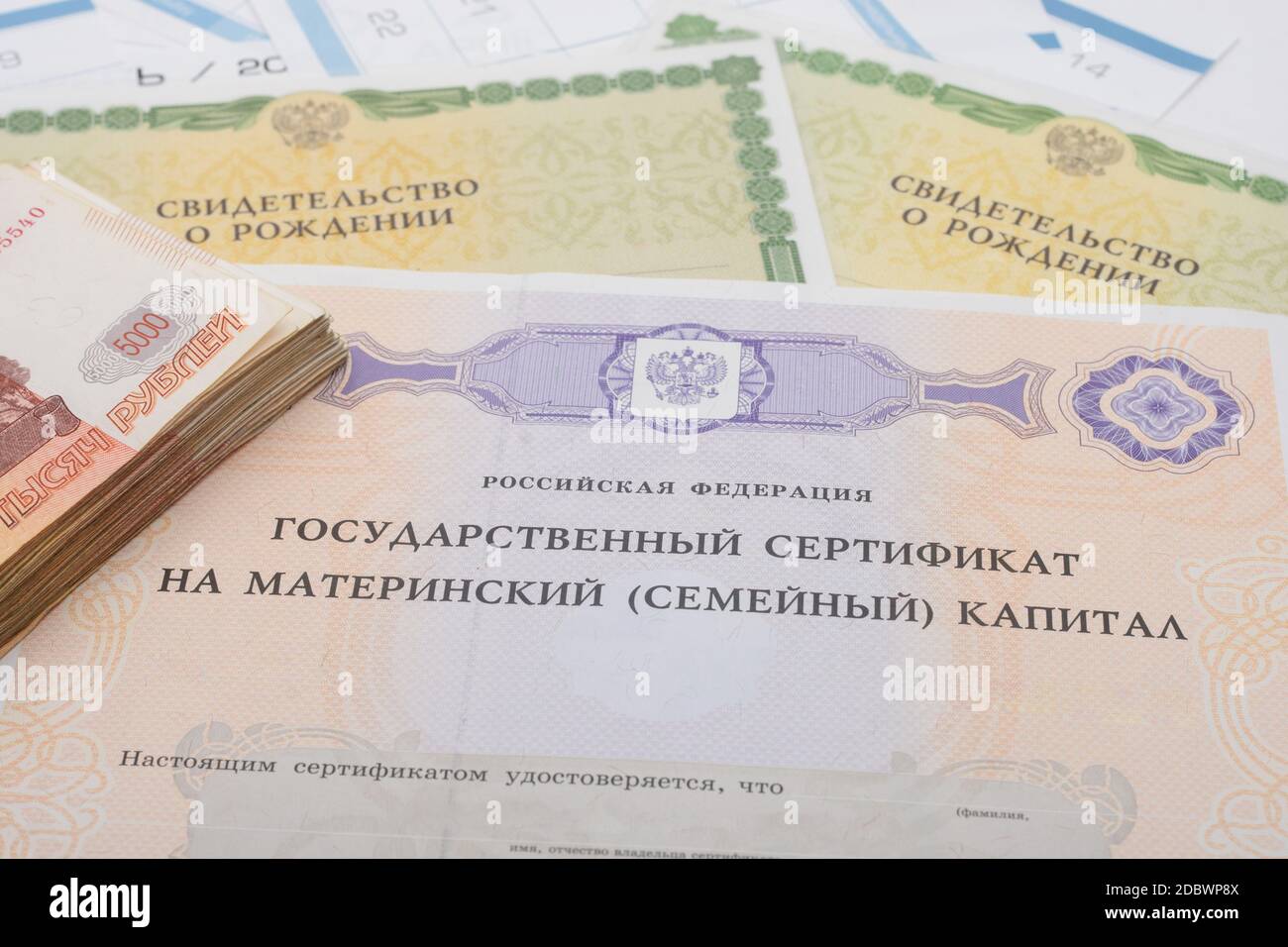 Certificato di Stato per il capitale di maternità, due certificati di nascita e un pacchetto di cinque millesimi fatture Foto Stock