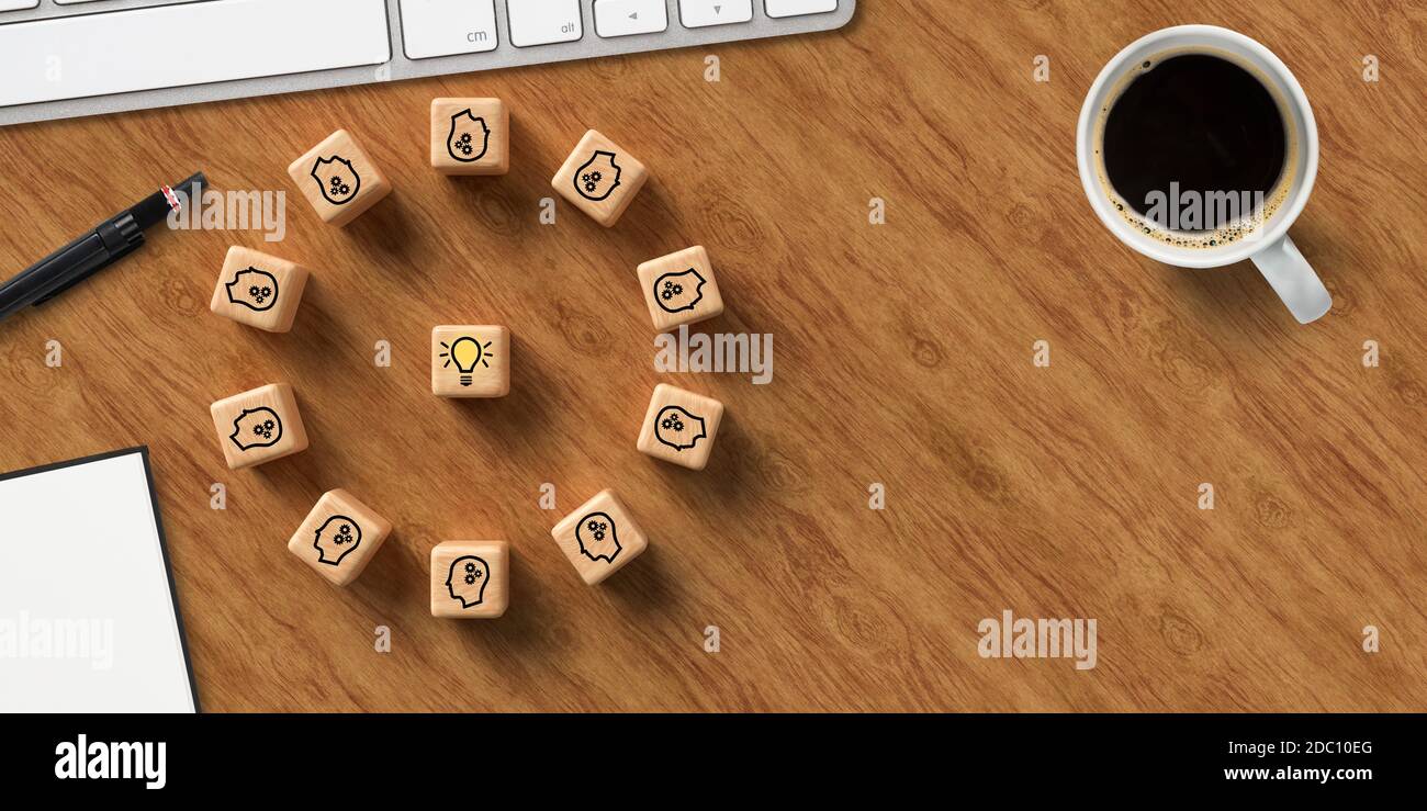 cubi che mostrano una sessione di brainstorming, tastiera e blocco note del computer su sfondo di legno Foto Stock