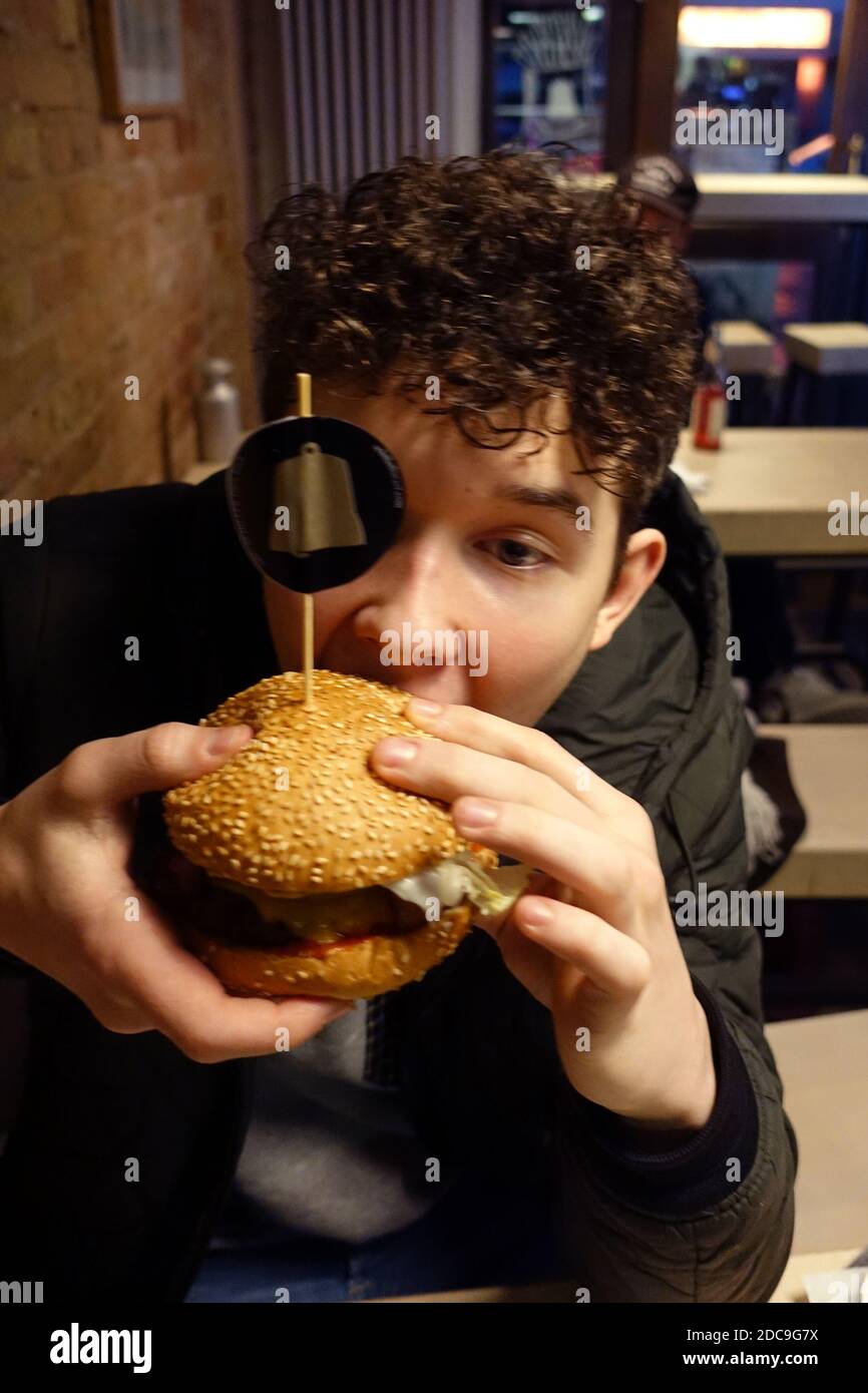 12.01.2019, Berlino, Berlino, Germania - Boy mangiare un hamburger. 00S190112D307CAROEX.JPG [RELEASE DEL MODELLO: SÌ, RELEASE DELLA PROPRIETÀ: NO (c) caro images / Sorg Foto Stock