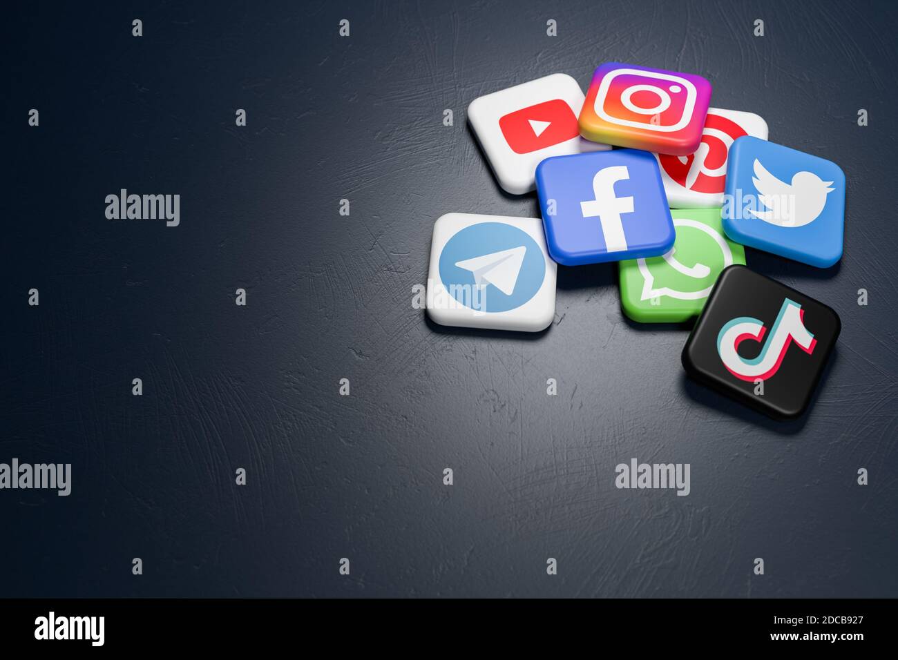 Logo dei principali social media e siti di messaggistica (YouTube, Instagram, Pinterest, Twitter, Facebook, Whatsapp, Telegram, Tiktok) su un mucchio di buie Foto Stock